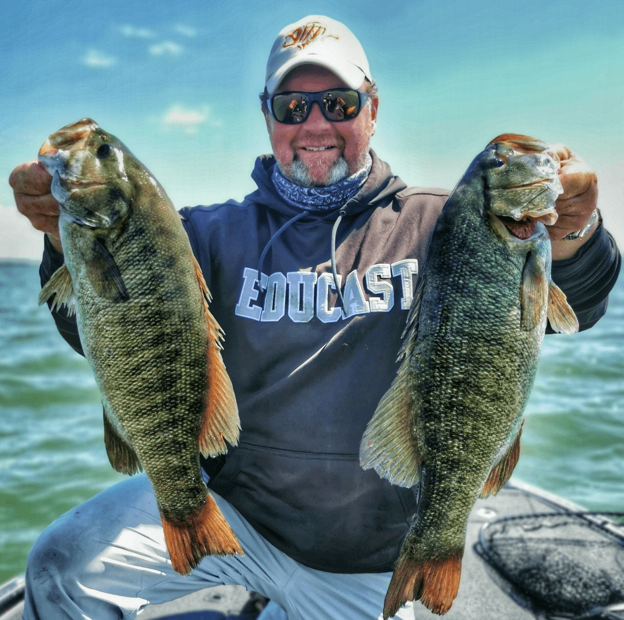 EduCast angler holding two trophy bass